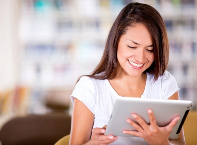 Woman using tablet at home representing convenient virtual IOP and online mental health support at Rooted Stillness in Newport Beach.